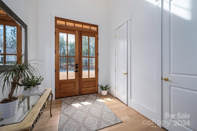 entryway featuring light hardwood / wood-style flooring and french doors