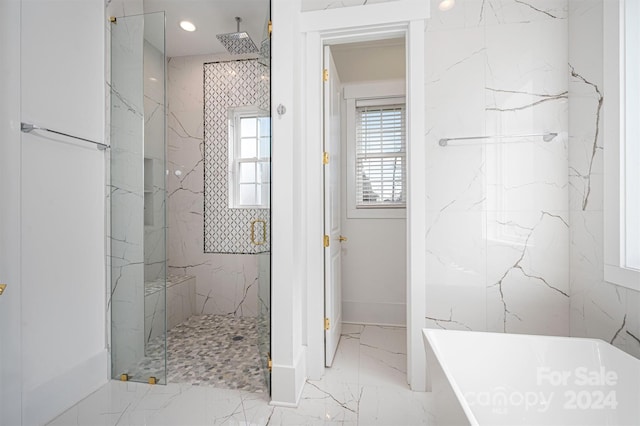 bathroom featuring shower with separate bathtub