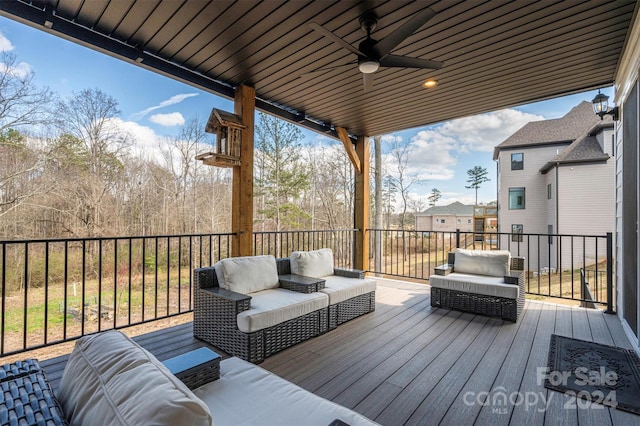 deck with outdoor lounge area and ceiling fan