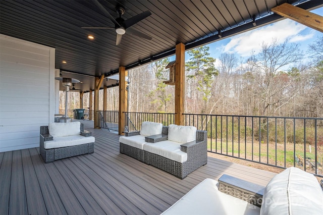 wooden deck with outdoor lounge area and ceiling fan