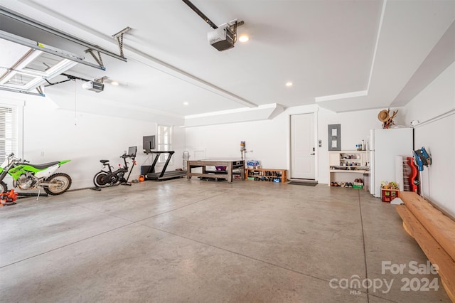 garage with electric panel and a garage door opener