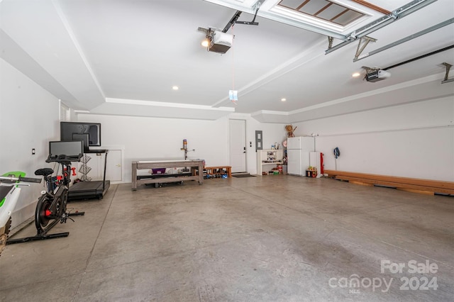 garage with electric panel, white refrigerator, and a garage door opener