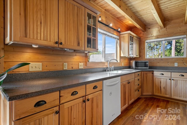 kitchen featuring a wealth of natural light, dishwasher, beamed ceiling, and dark hardwood / wood-style floors