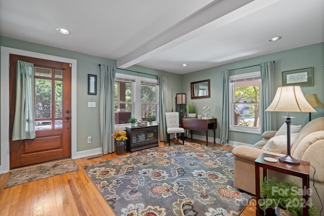 entryway with a healthy amount of sunlight, beam ceiling, and hardwood / wood-style floors