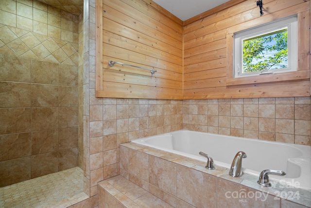 bathroom featuring separate shower and tub