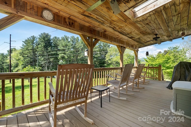 deck with ceiling fan and a lawn