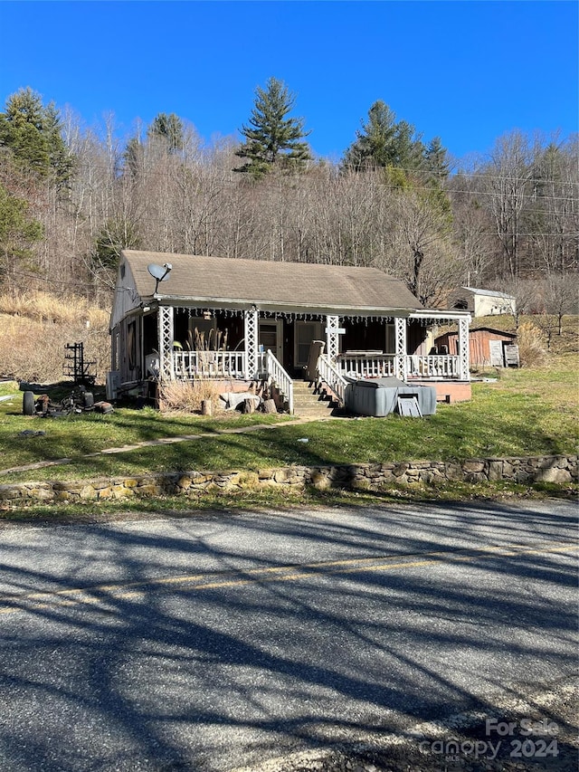 view of front of home with a porch and a front lawn