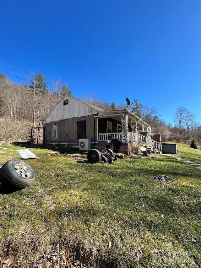 back of house with a lawn