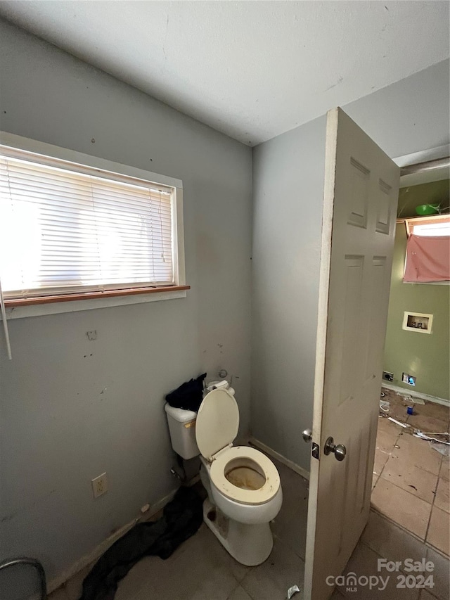 bathroom featuring tile floors and toilet