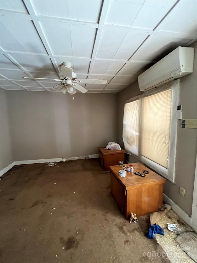 spare room with ceiling fan and a wall unit AC