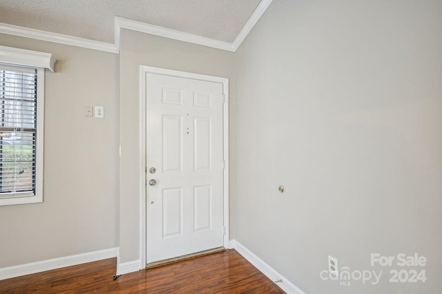 foyer with crown molding, a textured ceiling, and dark hardwood / wood-style flooring