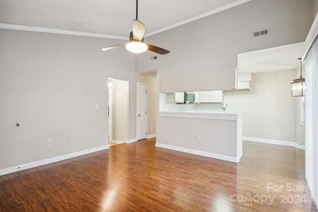 unfurnished living room with high vaulted ceiling, ornamental molding, wood-type flooring, and ceiling fan