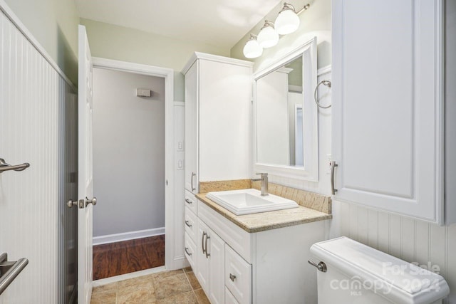 bathroom featuring tile floors, large vanity, and toilet