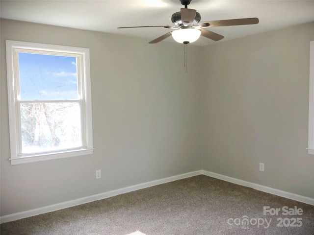 carpeted spare room featuring ceiling fan