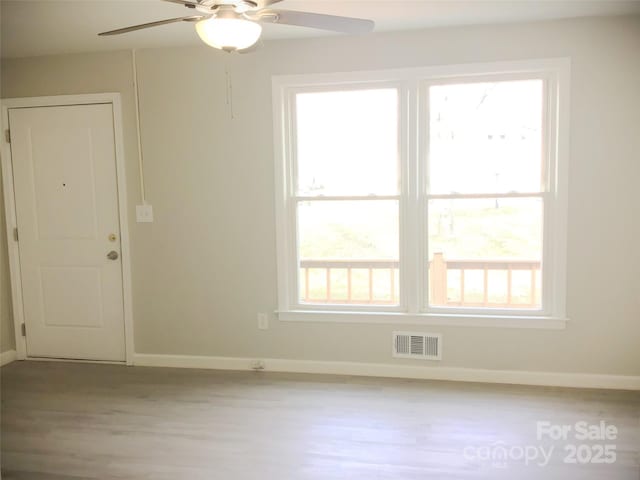 unfurnished room with ceiling fan, a healthy amount of sunlight, and light hardwood / wood-style floors