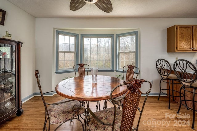 dining area featuring light hardwood / wood-style floors and ceiling fan