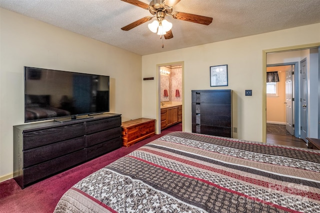 bedroom with connected bathroom, a textured ceiling, dark colored carpet, and ceiling fan