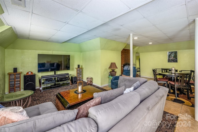 tiled living room featuring a drop ceiling