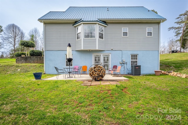 back of house with central AC, french doors, a lawn, and a patio area