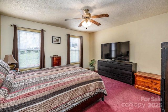 bedroom with a textured ceiling, carpet, and a ceiling fan