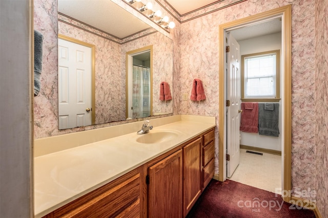 bathroom with tile patterned floors, visible vents, vanity, and wallpapered walls