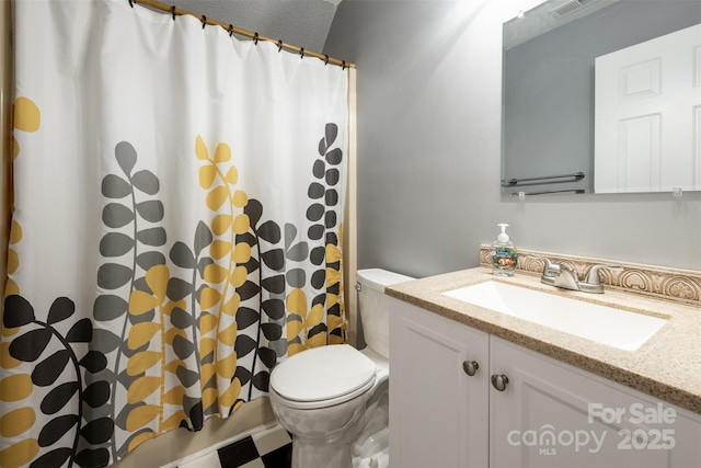 bathroom featuring vanity, a shower with shower curtain, and toilet