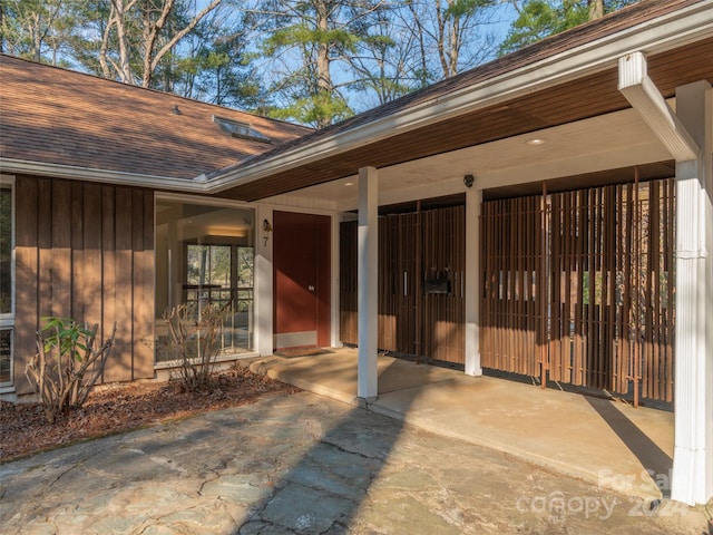 property entrance with a carport