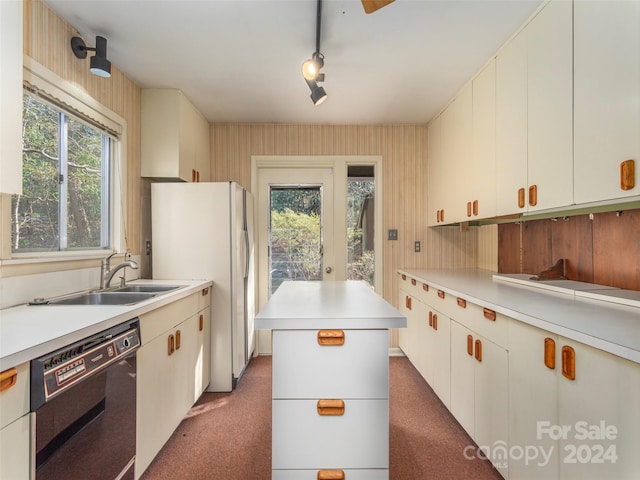 kitchen with white cabinets, a center island, dark carpet, and dishwasher