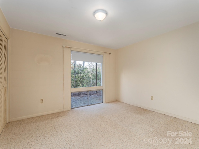 unfurnished room with light carpet