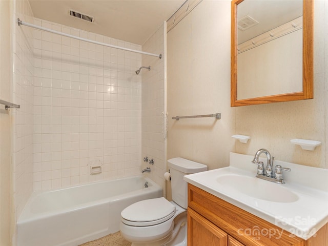 full bathroom featuring oversized vanity, toilet, and tiled shower / bath