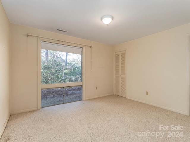 spare room with light colored carpet