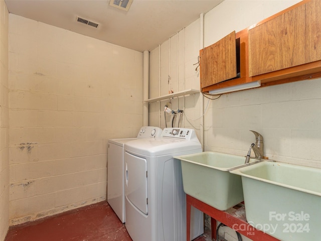 laundry room featuring washer hookup, cabinets, and separate washer and dryer