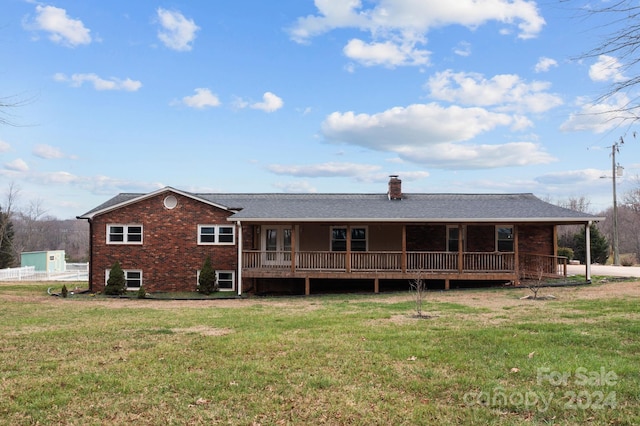 rear view of house featuring a lawn