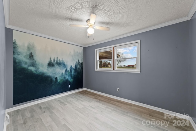 spare room featuring light hardwood / wood-style floors, ornamental molding, a textured ceiling, and ceiling fan