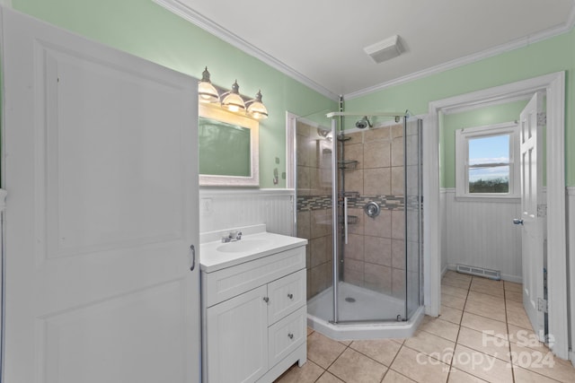 bathroom featuring crown molding, walk in shower, vanity with extensive cabinet space, and tile flooring