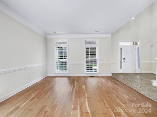 interior space featuring crown molding and light hardwood / wood-style floors