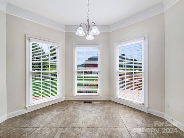 unfurnished dining area featuring ornamental molding, light tile patterned floors, and a notable chandelier