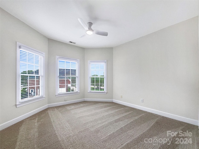 carpeted empty room with ceiling fan