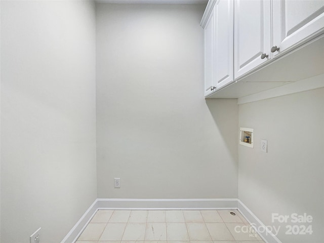 clothes washing area with washer hookup and cabinets