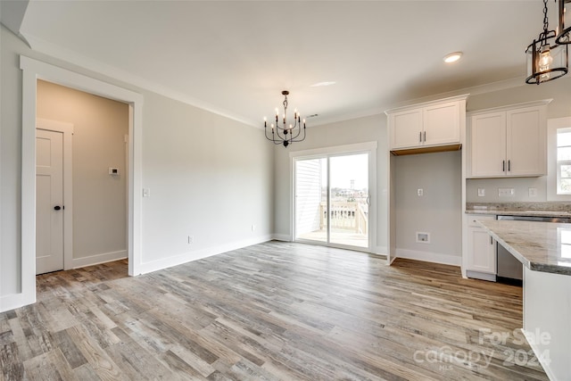 kitchen with light hardwood / wood-style flooring, white cabinets, and decorative light fixtures