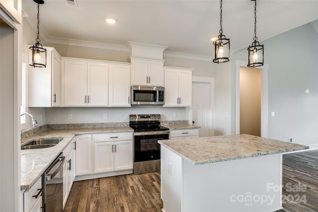 kitchen featuring a kitchen island, white cabinetry, sink, and appliances with stainless steel finishes