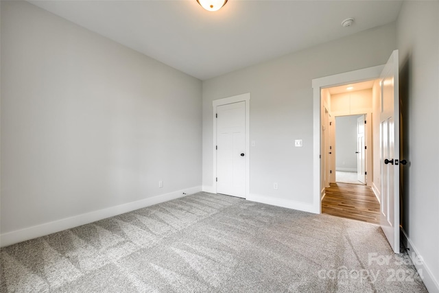 unfurnished bedroom with carpet flooring and a closet