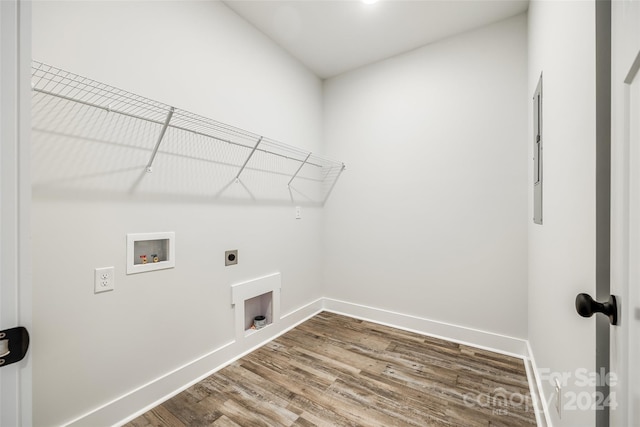 clothes washing area featuring hookup for an electric dryer, hardwood / wood-style floors, and washer hookup