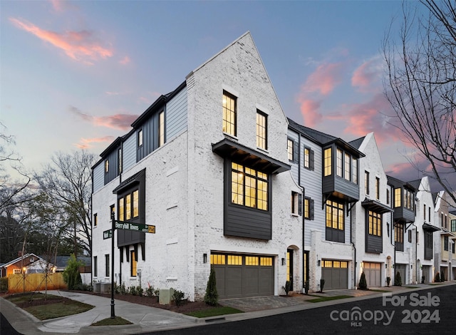 outdoor building at dusk with a garage