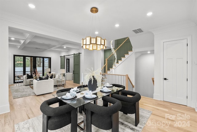 dining space featuring light hardwood / wood-style floors, beamed ceiling, a barn door, and coffered ceiling