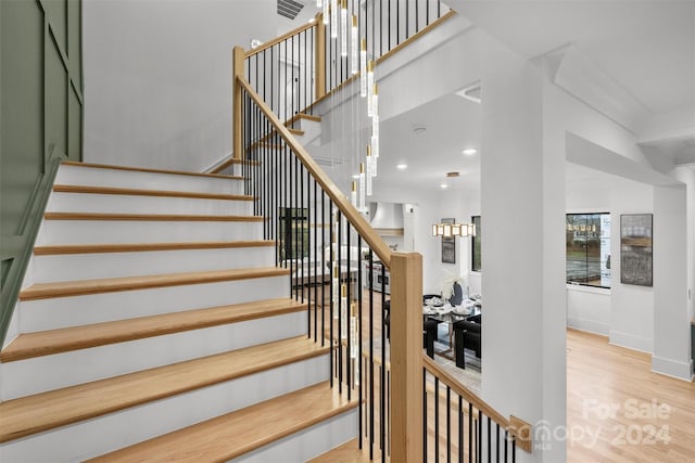 stairs with light hardwood / wood-style flooring