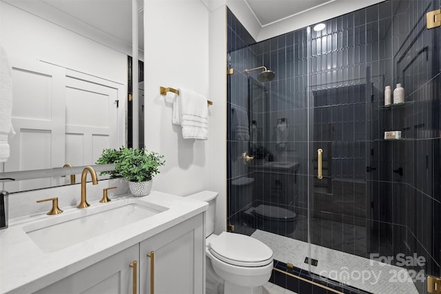 bathroom with a shower with shower door, toilet, and vanity