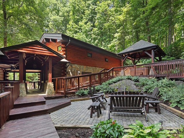 view of patio with ceiling fan, a deck, and a gazebo