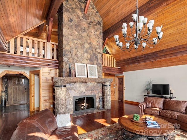 living room featuring a chandelier, hardwood / wood-style floors, a stone fireplace, and high vaulted ceiling