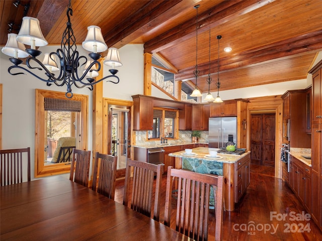 kitchen with pendant lighting, a center island, stainless steel appliances, backsplash, and light stone counters